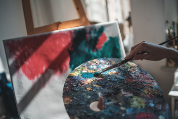 woman artist paint with brushes and oil dye