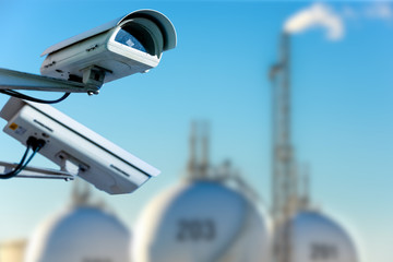 CCTV camera concept with refinery on background