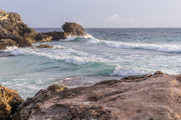 Caribbean sea coast with rocks and hello breaking