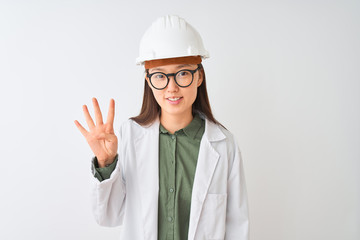 Young chinese engineer woman wearing coat helmet glasses over isolated white background showing and pointing up with fingers number four while smiling confident and happy.