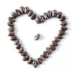 Heart made of chia seeds isolated on white background.