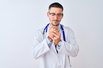 Young doctor man wearing stethoscope over isolated background Suffering pain on hands and fingers, arthritis inflammation