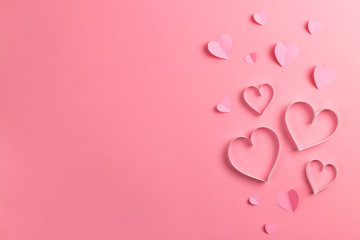 Composition for Valentine's Day February 14th. Delicate pink background and pink hearts cut out of paper. Greeting card. Flat lay, top view, copy space. - obrazy, fototapety, plakaty
