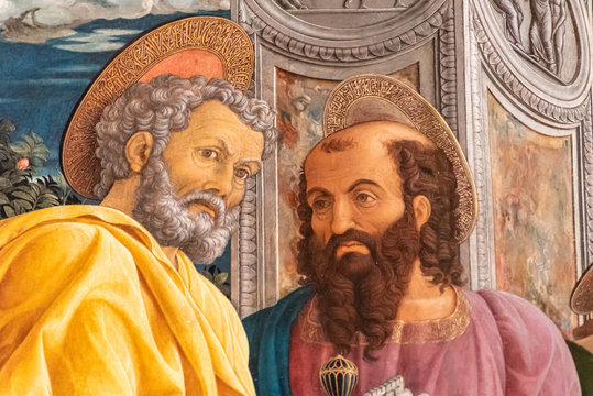 Detail of colorful medieval religious painting showing two holy men talking
