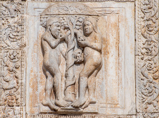 Fototapeta na wymiar Scene of the original sin carved on marble wall