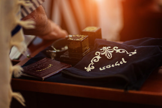 A set of tefillin with verses from Torah written on them and a pouch saying "tefillin" in Hebrew on it.