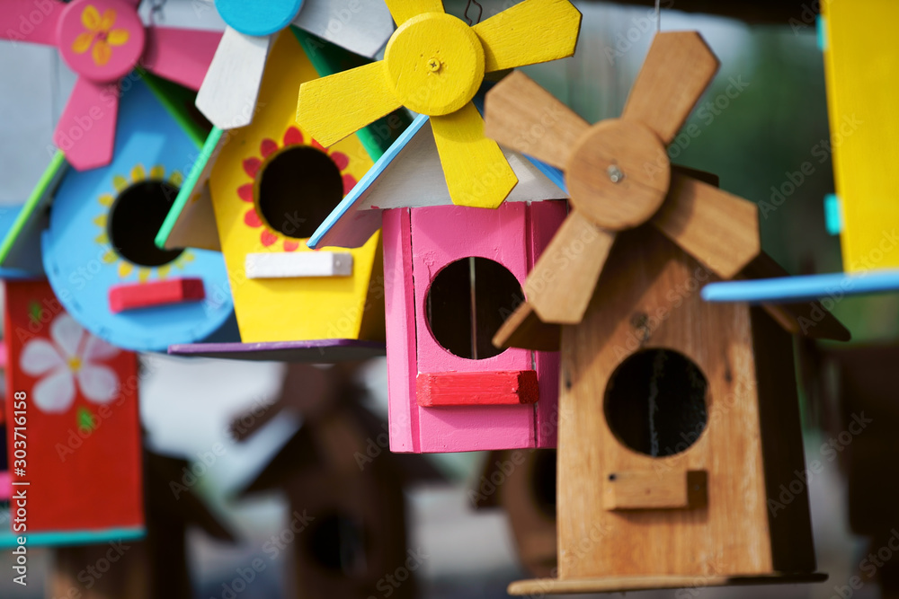 Poster close up of beautiful colored wooden bird house