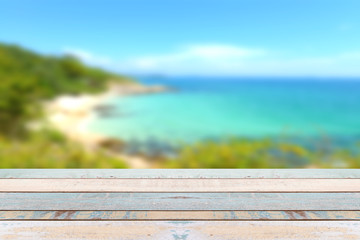 Fototapeta na wymiar Wood table top with blurred nature scene tropical beach