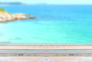 Wood table top with blurred nature scene tropical beach