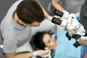 Naklejka premium Pretty woman's teeth treatment in dental clinic