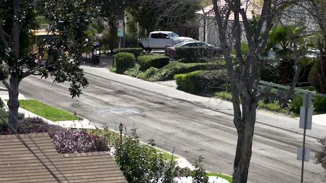 Construction crew work to repave city road by ripping up the old one with griding machinery and excavating it into dump trucks.