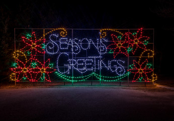Colorful festive Holiday Christmas Light display of Seasons Greeting spelled out