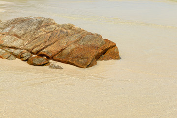 Fototapeta na wymiar Beach with Rocks Sand and Waves