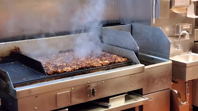 Grill in a fast food Mexican restaurant with organic, naturally fed chicken being grilled