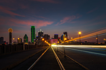 Dallas Texas. Long exposure with streaking car and train lights and clouds - 303720181