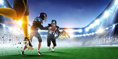 Obraz na płótnie Canvas American football players fight for ball. Mixed media