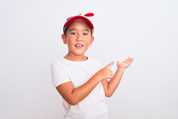 Beautiful kid boy wearing fanny colorful cap with propeller over isolated white background amazed...