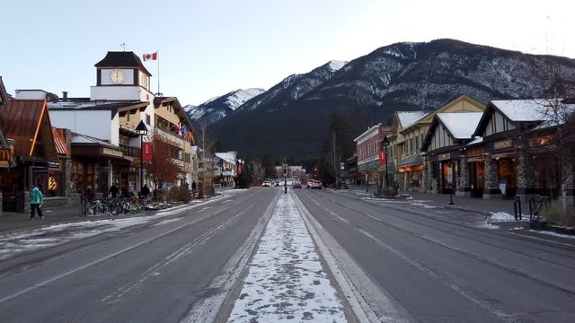 Cars and people on Banff ave in Banff, Alberta in winter
