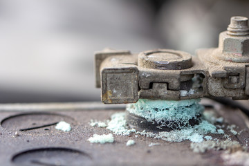 Mechanic checking car Battery terminal in a garage .