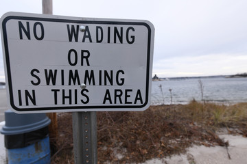 No wading or swimming in this area sign