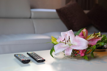 Obraz na płótnie Canvas remote television put on white table inside home living room