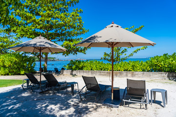 Umbrella and chair on the beach and sea with blue sky