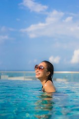 Portrait beautiful young asian women happy smile relax outdoor swimming pool in resort