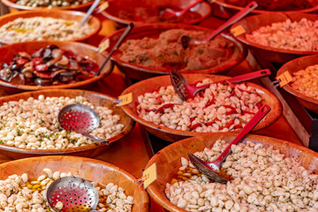 Pickled olive .assortment .and other vegetables on farmers market stall.