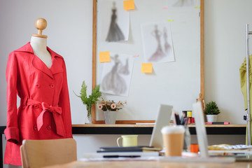 Cropped shot view of Fashion Designer stylish showroom working as fashion and drawing sketches for clothes in atelier.