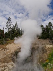 Close up of smoke and steam spewing out of the Dragon's Mouth Spring at Yellowstone National Park.