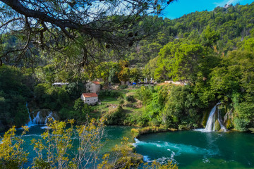 Fototapeta na wymiar View of waterfalls, lakes, and old mill buildings in Krka National Park, Croatia