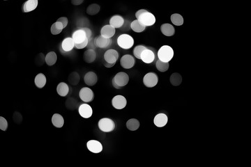 Abstract background white bokeh dispersion on a black background 