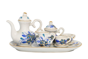 A ceramic tea set with tea pot, sugar jar and cups. The design of porcelain is blue and gold flower hand paint. Isolated on white background with clipping path