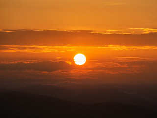 Bright sun and orange dramatic sunrise sky