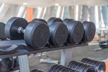 Fototapeta na wymiar row of dumbbells in a modern gym