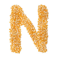 Letter N of the English alphabet from from yellow dry corn  on a white isolated background. Food pattern made from corn. bright alphabet for shops. cereal for corn porridge