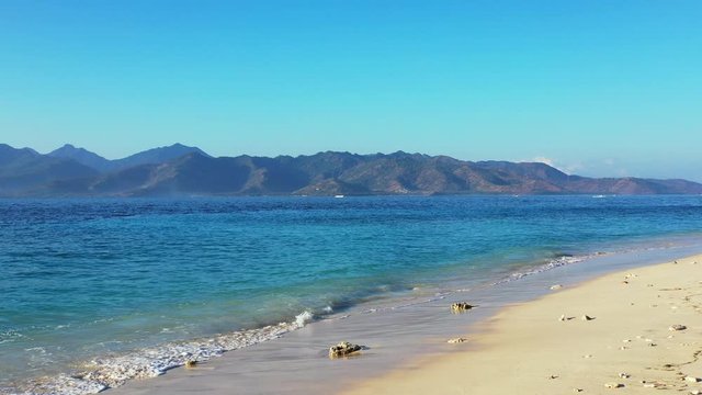 One Laiya Beach Resort In Batangas, Philippines - Waves Crashing On The Stony Shore With Beautiful Mountains On The Background - Wide Shot