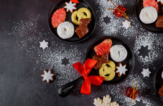 Christmas cookies in iron pan on a dark wooden table. © Olesya