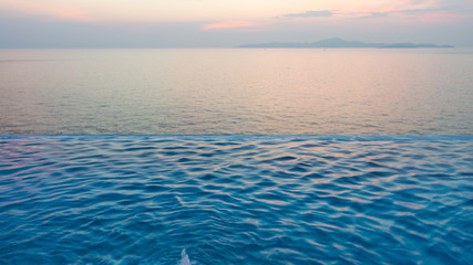 Naklejka na ściany i meble Swimming Pool with sunset on the sea