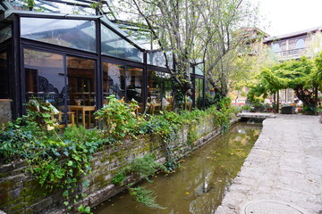 A glass house next to the canal at Shuhe ancient town, Lijiang, China.