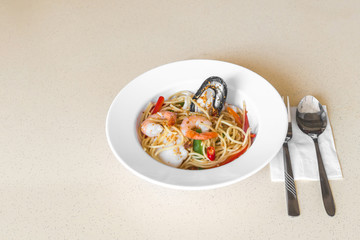 Spicy seafood spaghetti aglio olio. Food on table concept.
