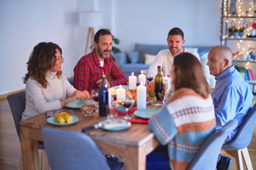 Beautiful family smiling happy and confident. Eating roasted turkey celebrating Christmas at home