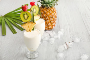 Glasses of tasty Pina Colada cocktail on table