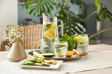 Healthy infused water with ingredients on table