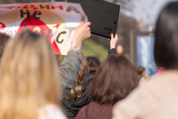 Young people at a peaceful demonstration in a modern city.