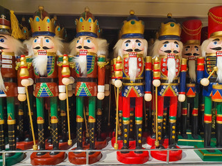 Several different nutcraker soldiers toys displayed in a store, christmas decoration for sale in market Happy New Year