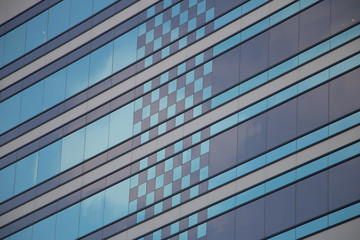Fototapeta premium Blue patterned windows on side of building 