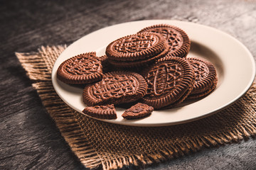 Chocolate sandwich cookie wafers on white plate.