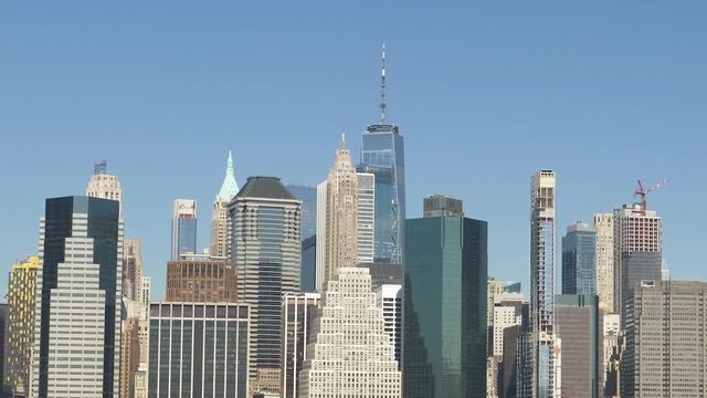 Manhattan Skyline Buildings zooms out to show East River and Brooklyn Bridge Park,