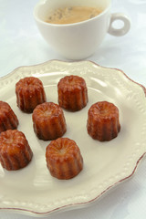 several cannelés on a plate	